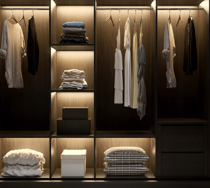 Bespoke fitted wardrobe showcasing neatly arranged clothing and storage solutions.