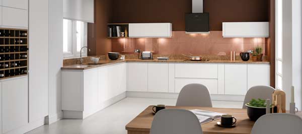 A modern handleless kitchen with white cabinets