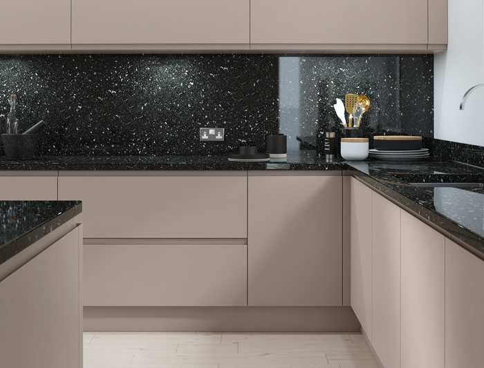 A kitchen with black speckled quartz worktops