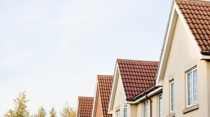 rooftops of residential houses against a clear sky showcasing modern architecture and home design elements