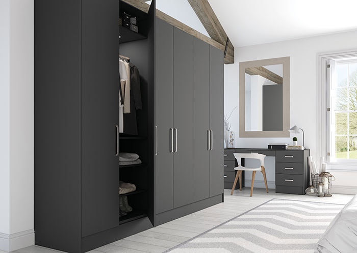 How Much Do Fitted Wardrobes Cost? In this complete guide, we’ll detail the average cost of fitted wardrobes, what impacts their price, ways to budget, the pros and cons of going bespoke, the value they may add to your home, and how to ensure you get an accurate quote. Whether you want a single alcove unit or a luxurious walk-in wardrobe, Bookham Kitchens shares everything UK homeowners need to know before making an investment.