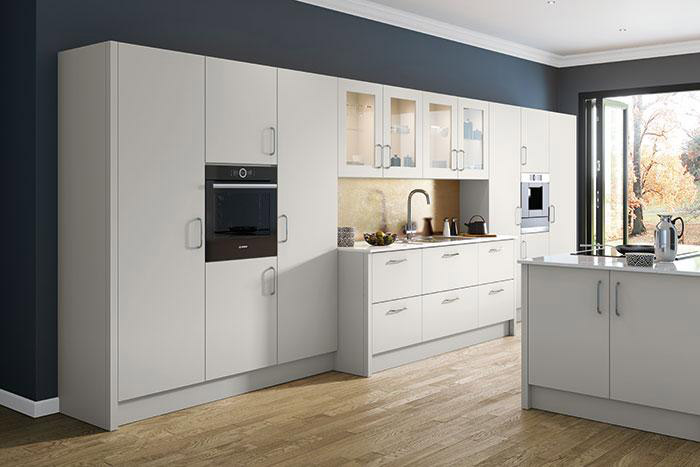 A fitted kitchen with white cabinets
