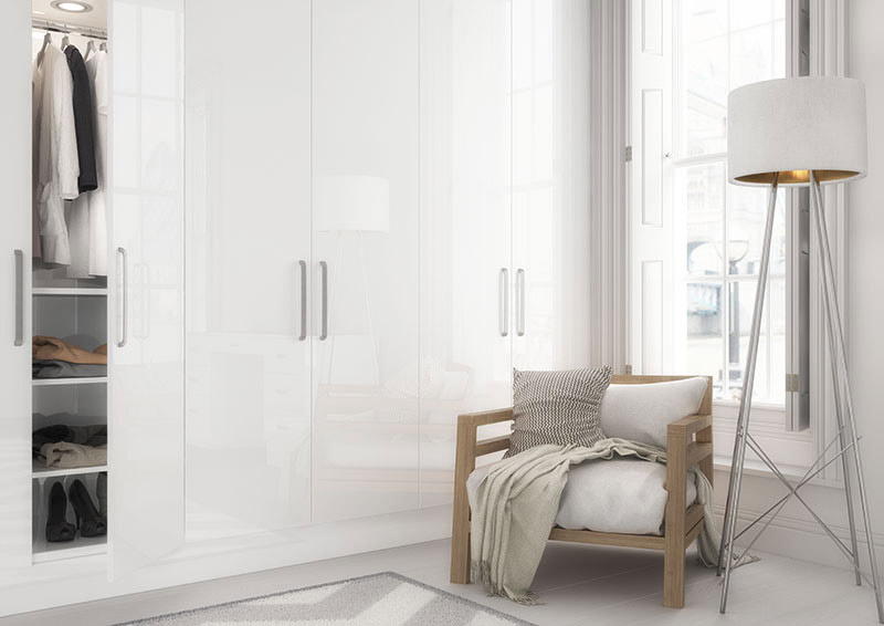 A white fitted wardrobe in a bedroom