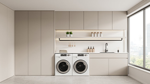 A utility room with white fitted cabinets