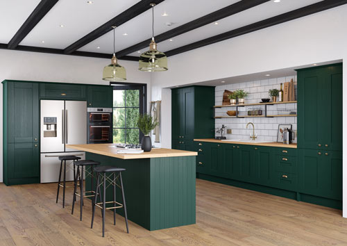 A traditional kitchen with deep green cabinets